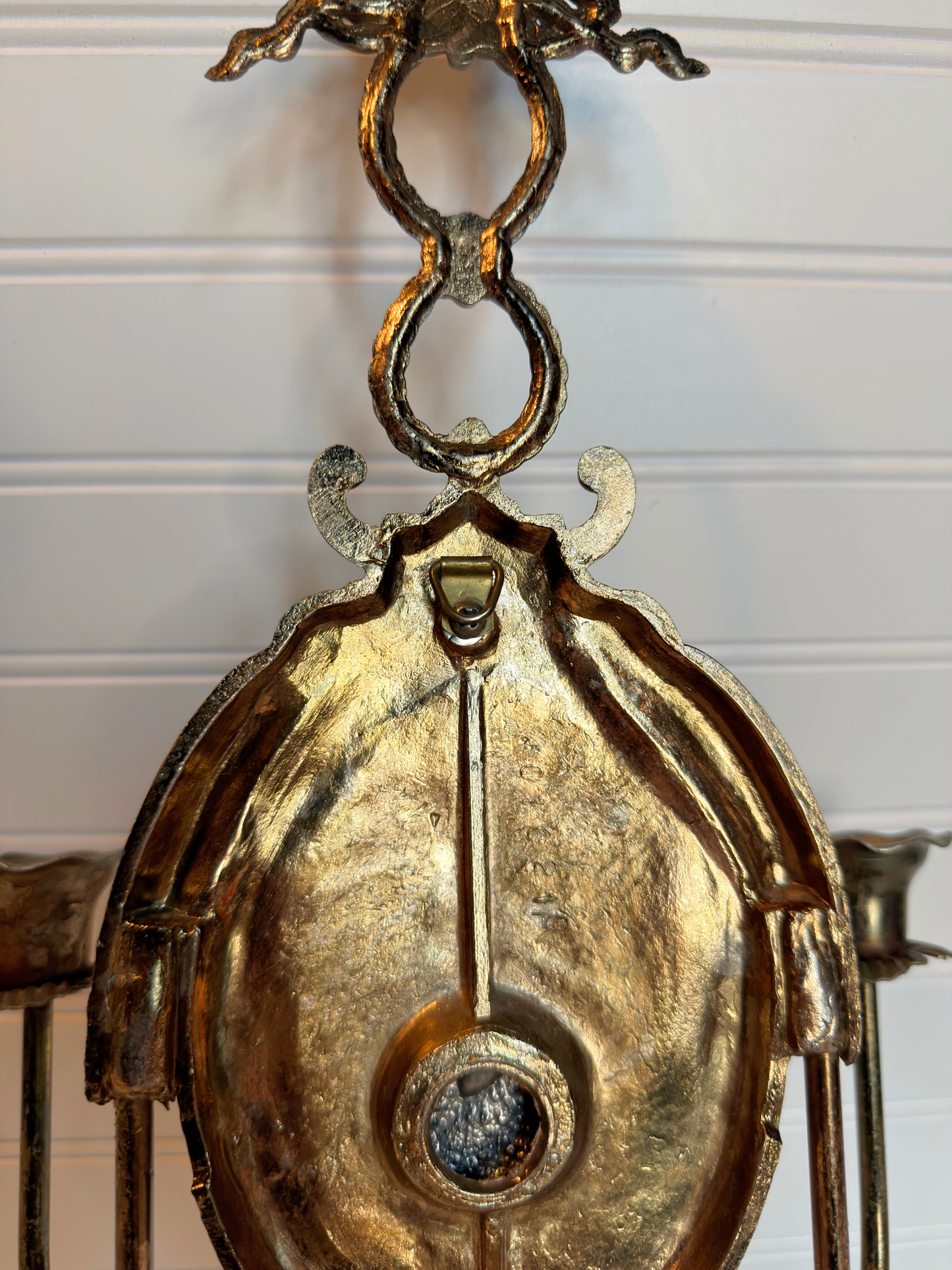 back close up Decorative metal wall sconce with figurative lady design on a white background