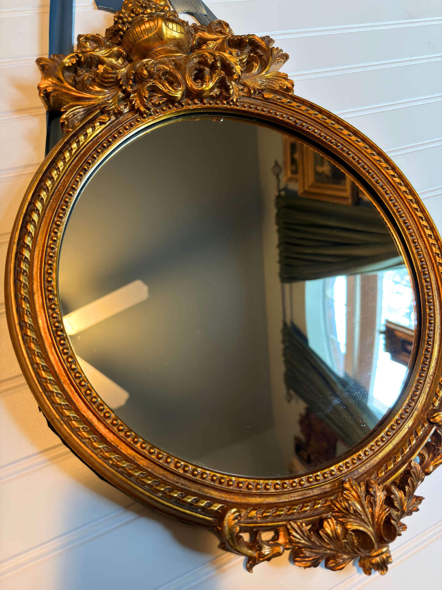 close up of ornate gold mirror