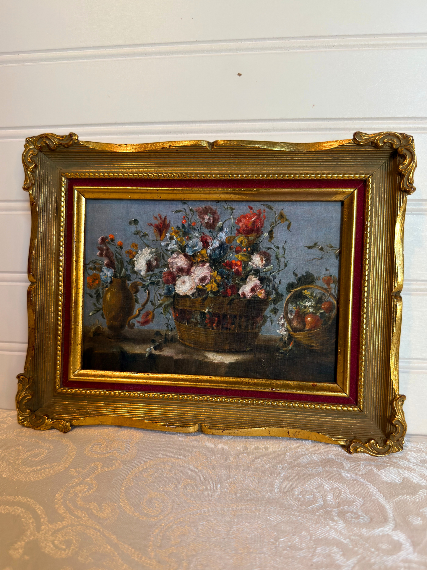 Framed print of flowers in a basket on a white background