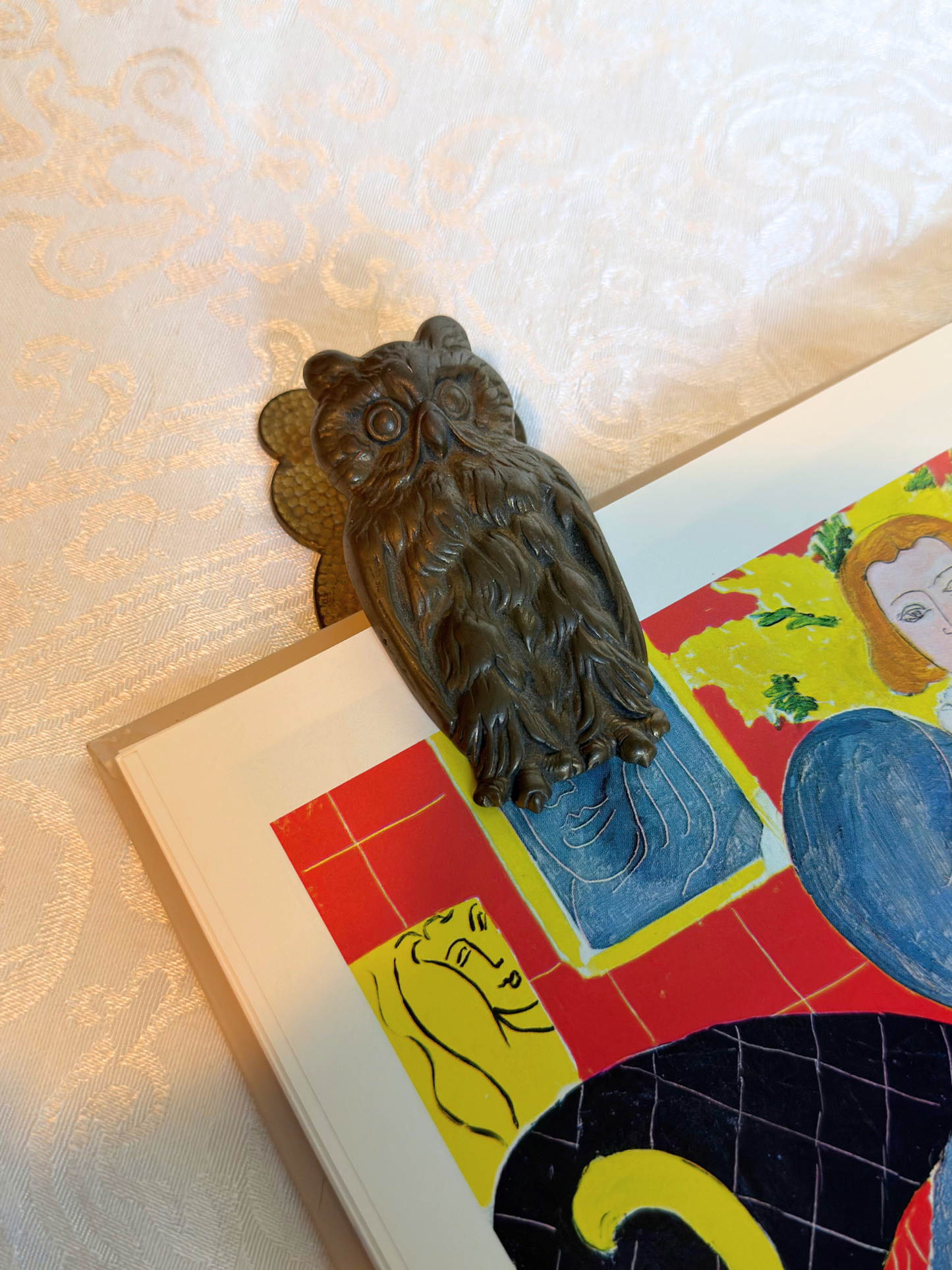 owl hand clip clipped on a book and on a white background