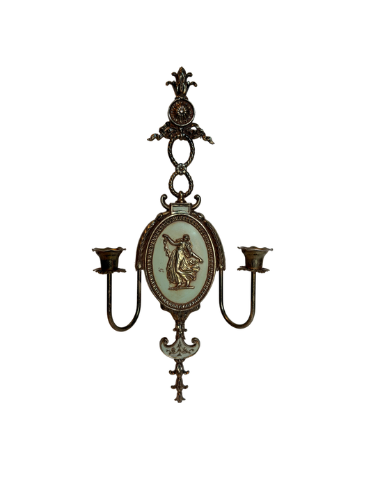 Decorative metal wall sconce with figurative lady design on a white background