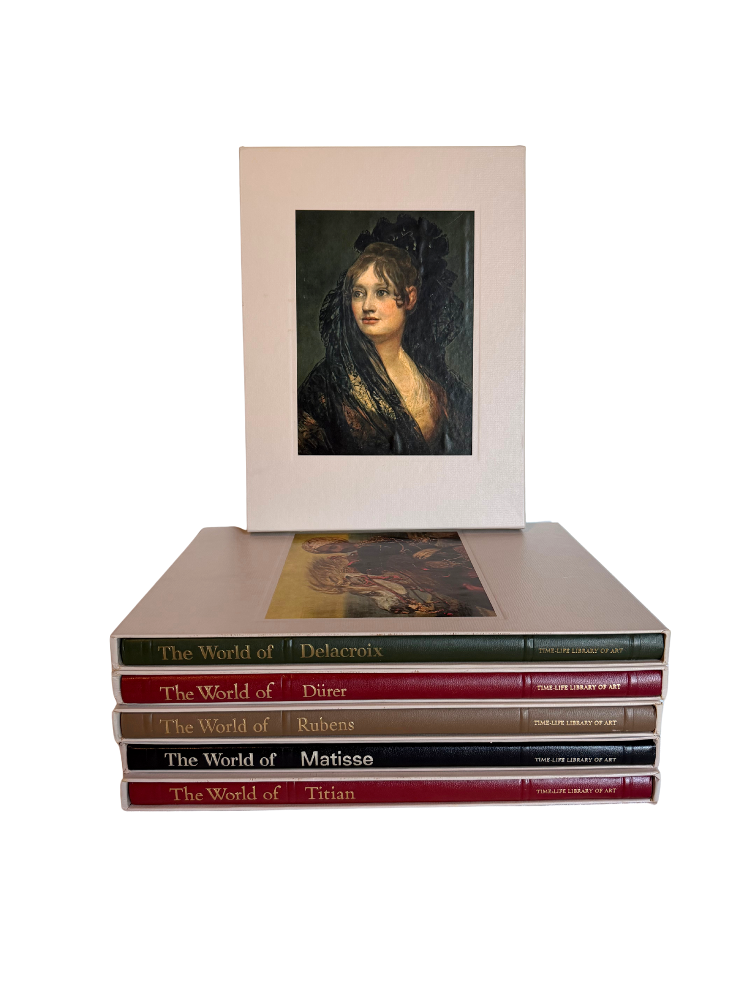 Stack of books titled 'The World of Delacroix', 'The World of Durer', 'The World of Rubens', and 'The World of Titian' with a framed portrait on top.
