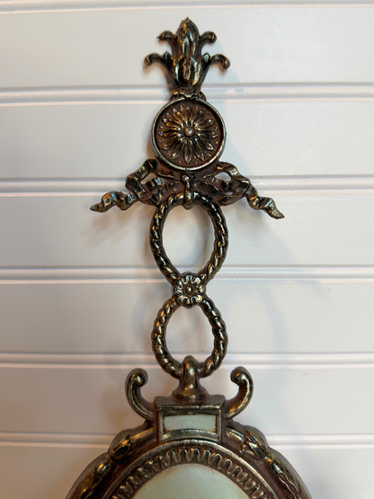 close up Decorative metal wall sconce with figurative lady design on a white background