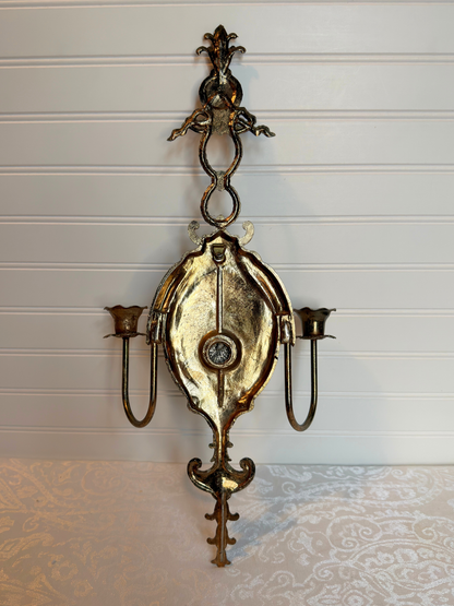 back of close up Decorative metal wall sconce with figurative lady design on a white background