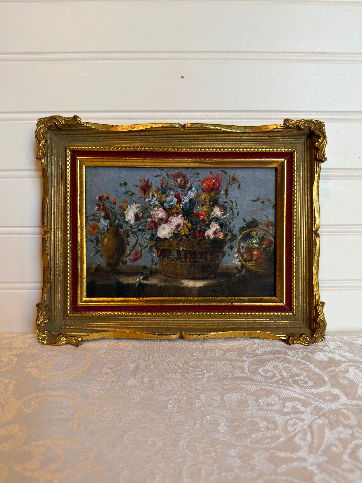 Framed print of flowers in a basket on a white background