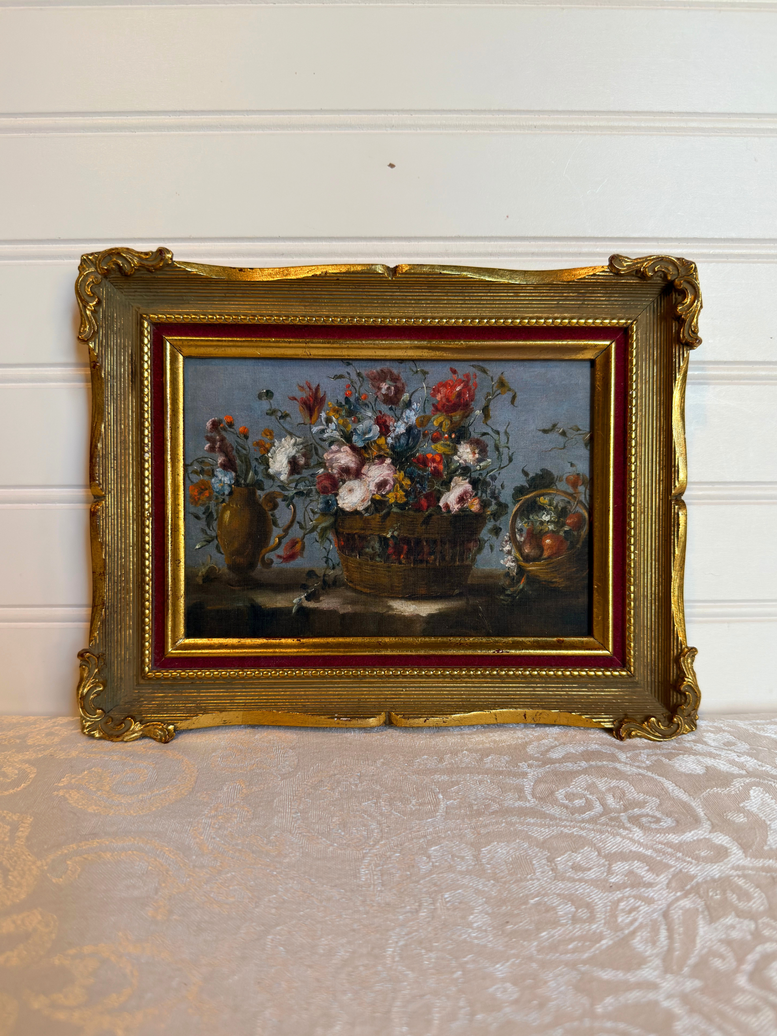 Framed print of flowers in a basket on a white background