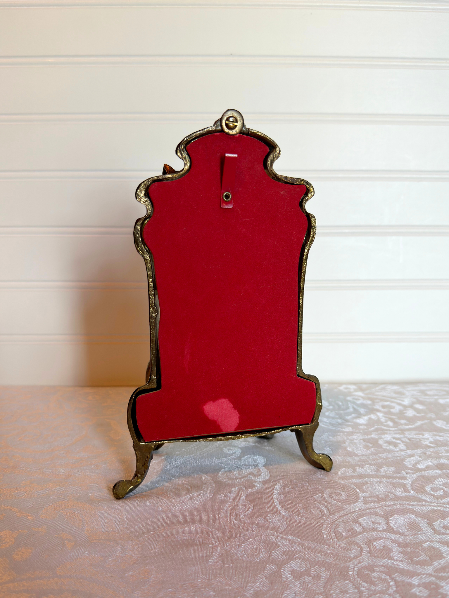 back of ornate vitrine jewelry box red backing on a white background