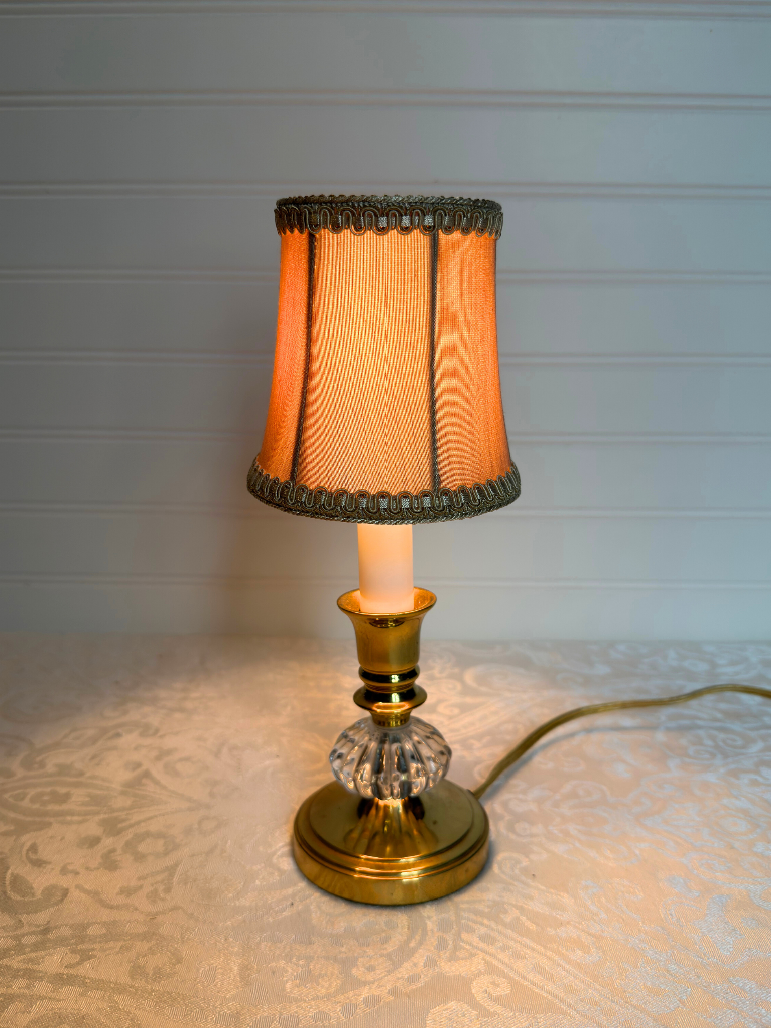Table lamp with a decorative shade on a textured surface