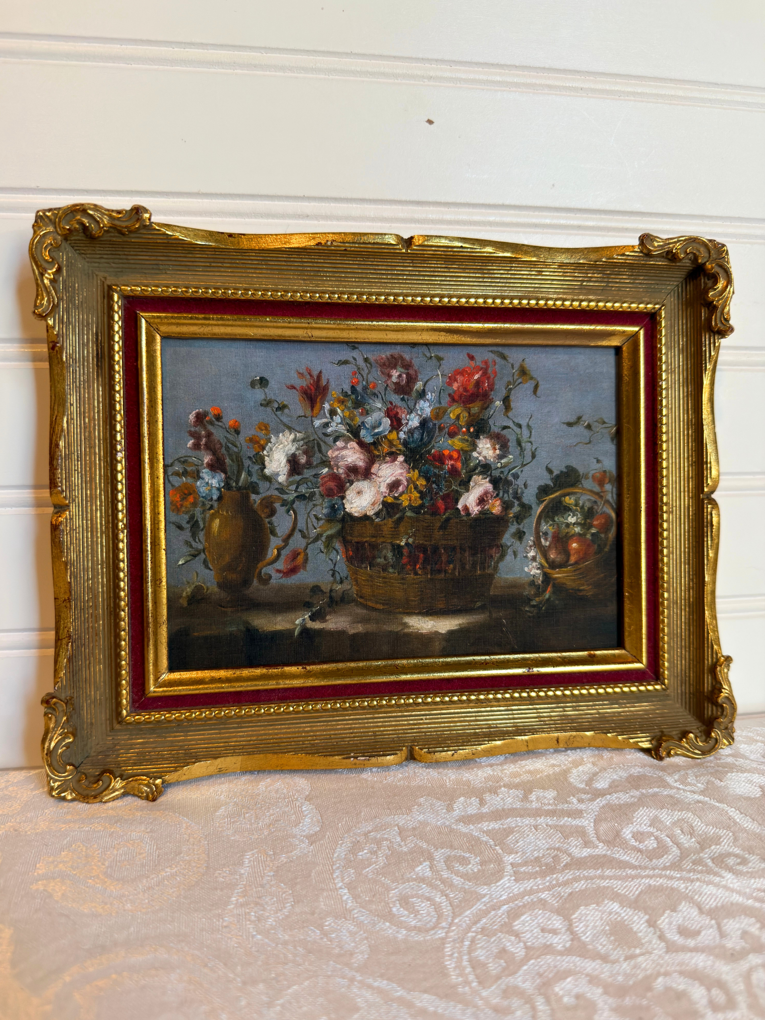 Framed print of flowers in a basket on a white background