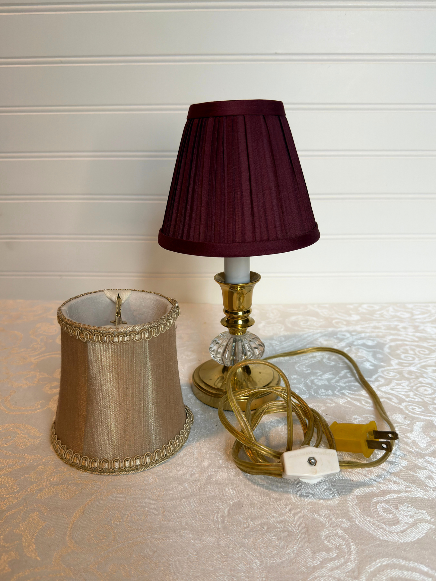 Two lampshades on a textured surface with a neutral background