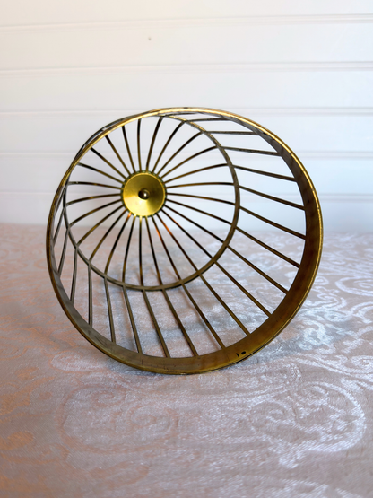 bottom of decorative bird cage on a white textured surface