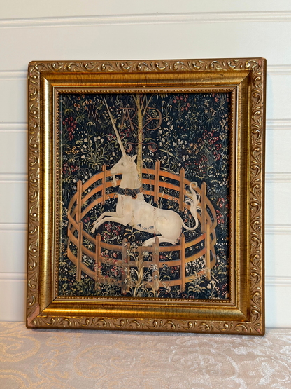 Decorative tapestry print with a unicorn in a gold frame on a white background