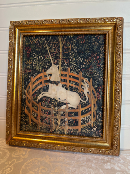 Decorative tapestry print with a unicorn in a gold frame on a white background