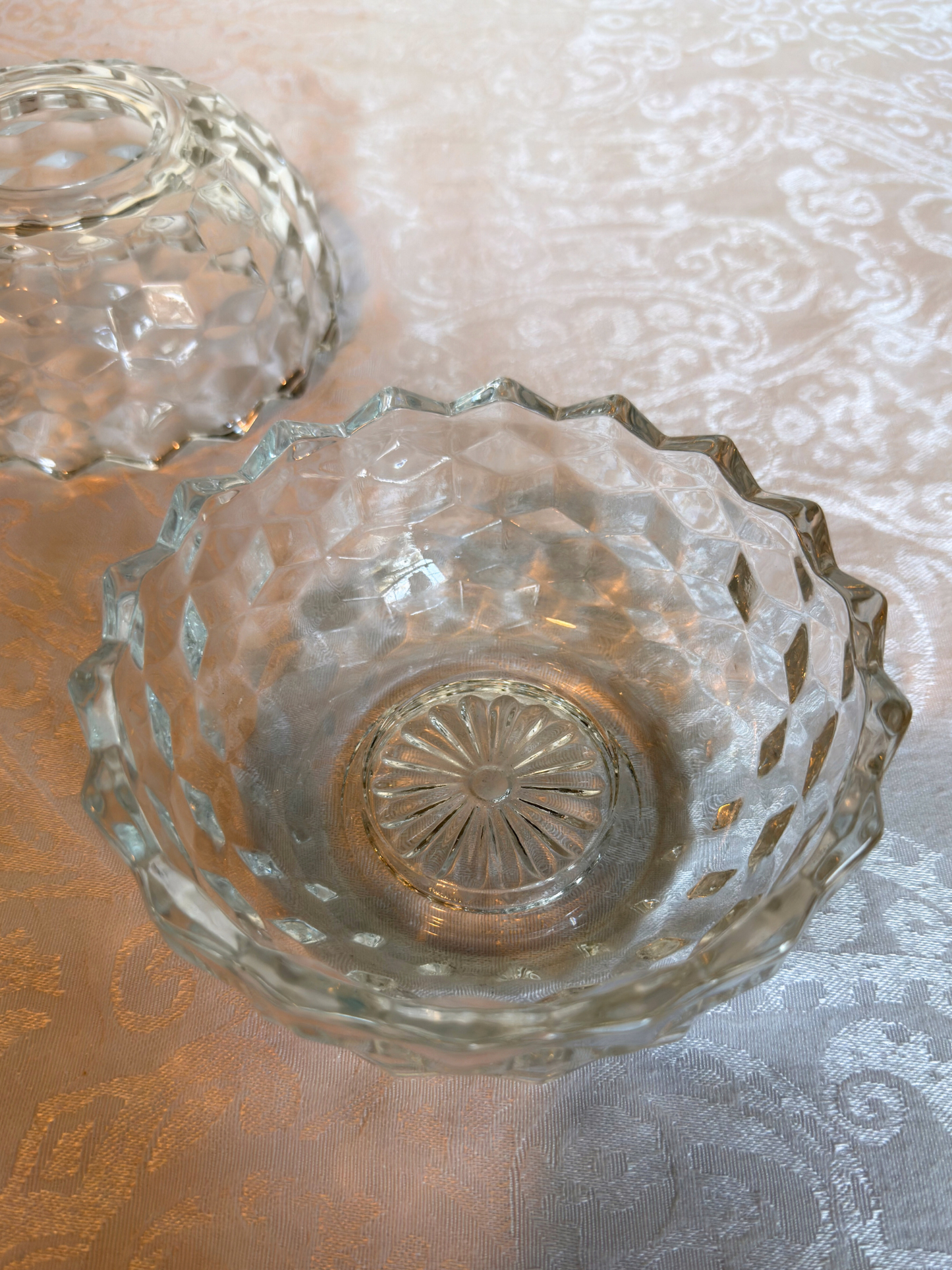 bottom of clear glass candle holder on a white texture surface