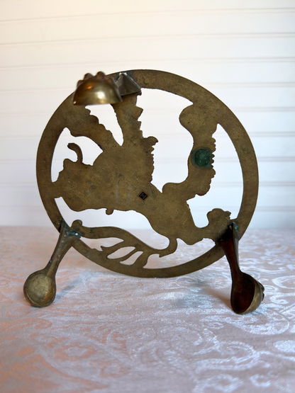 bottom of brass stand on white textured surface 