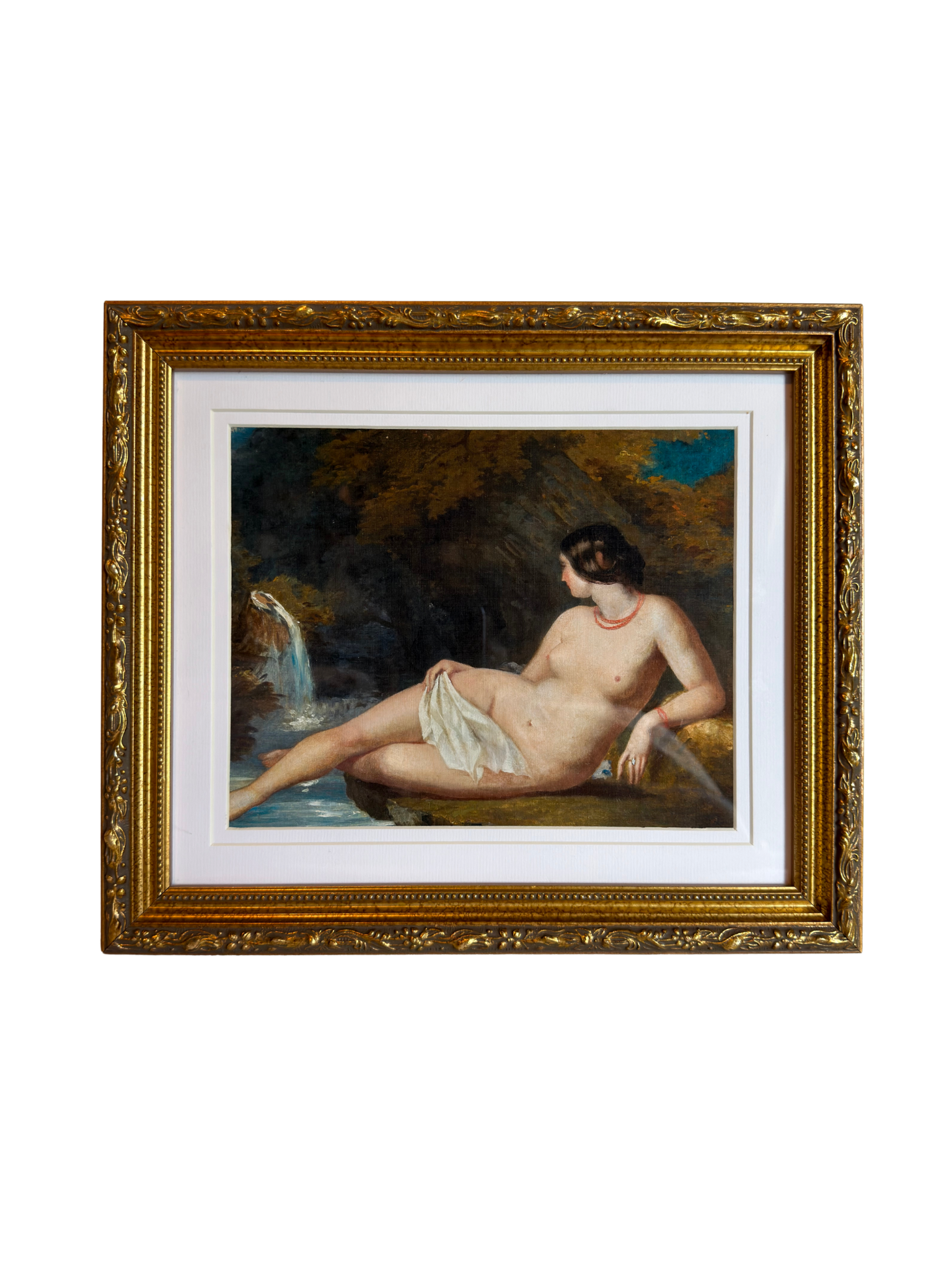 Framed painting of a nude woman by a waterfall with a gold frame.