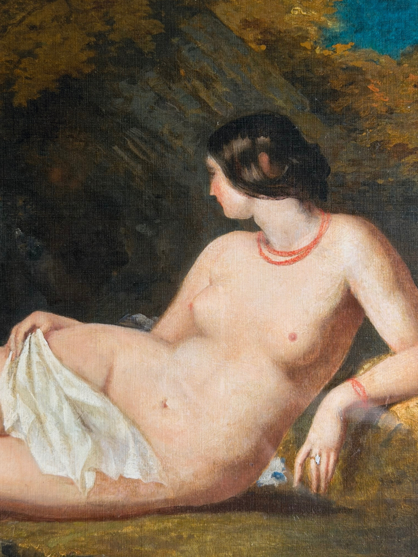Nude figure in a landscape setting with greenery