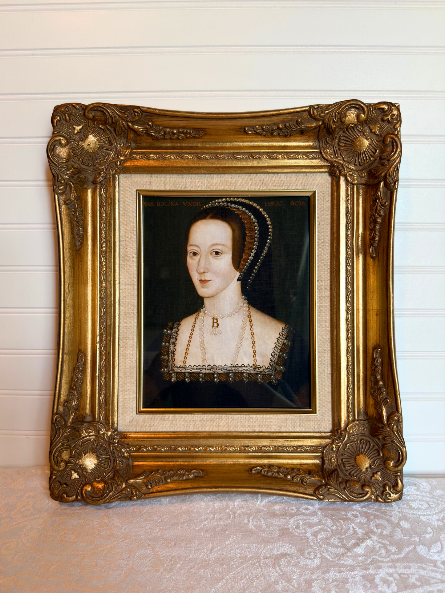 Anne Boleyn portrait in a gold frame on a white background