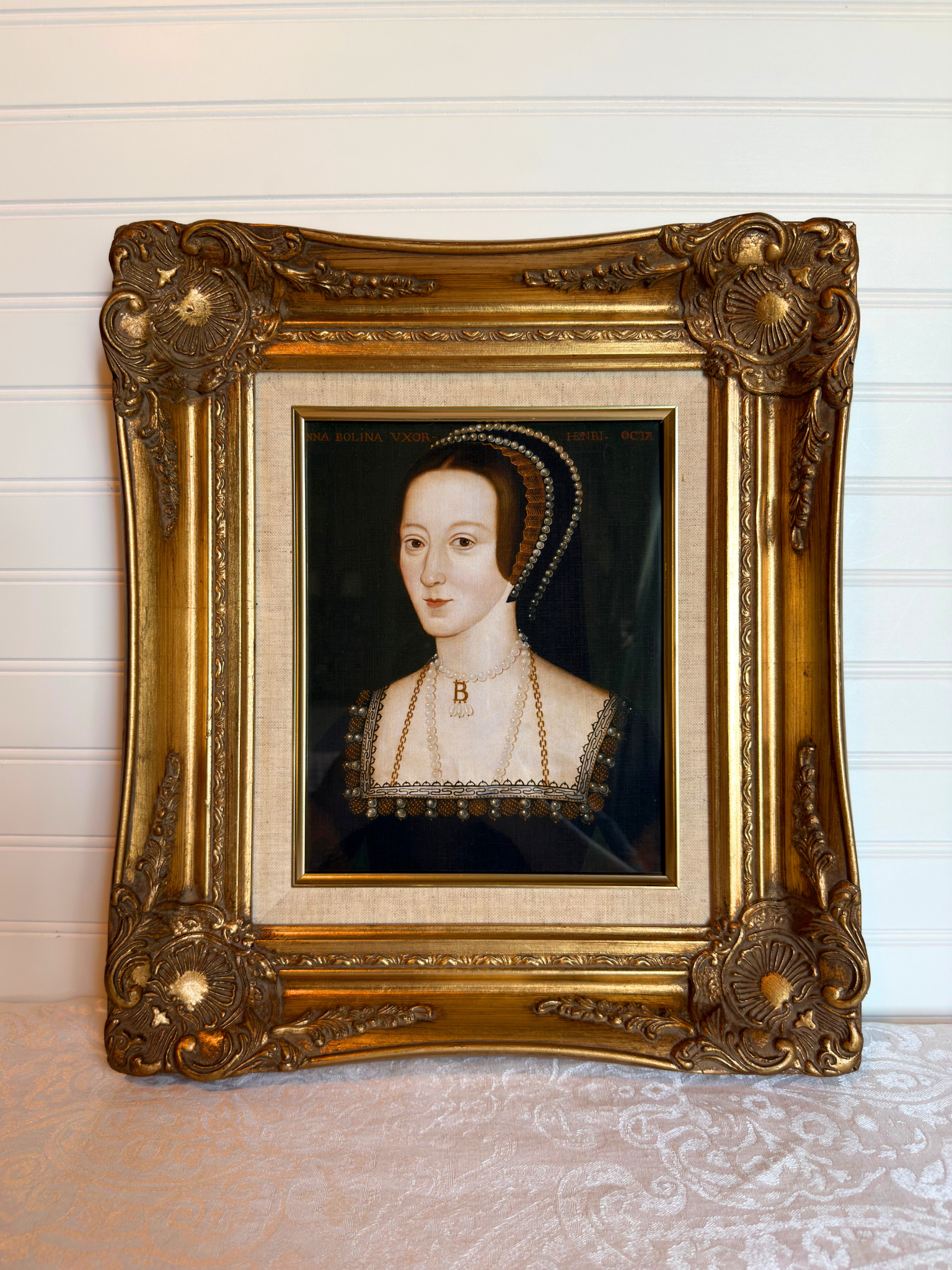 Anne Boleyn portrait in a gold frame on a white background