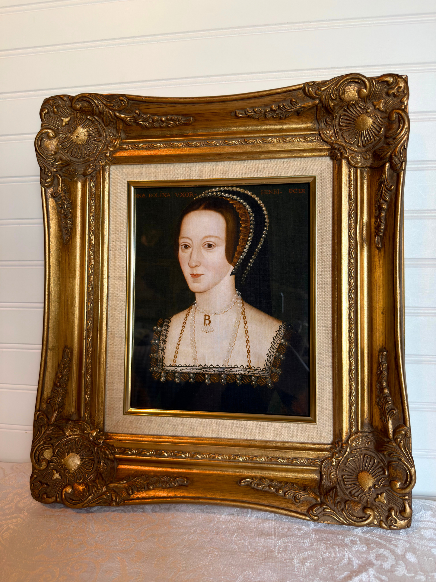 Anne Boleyn portrait in a gold frame on a white background