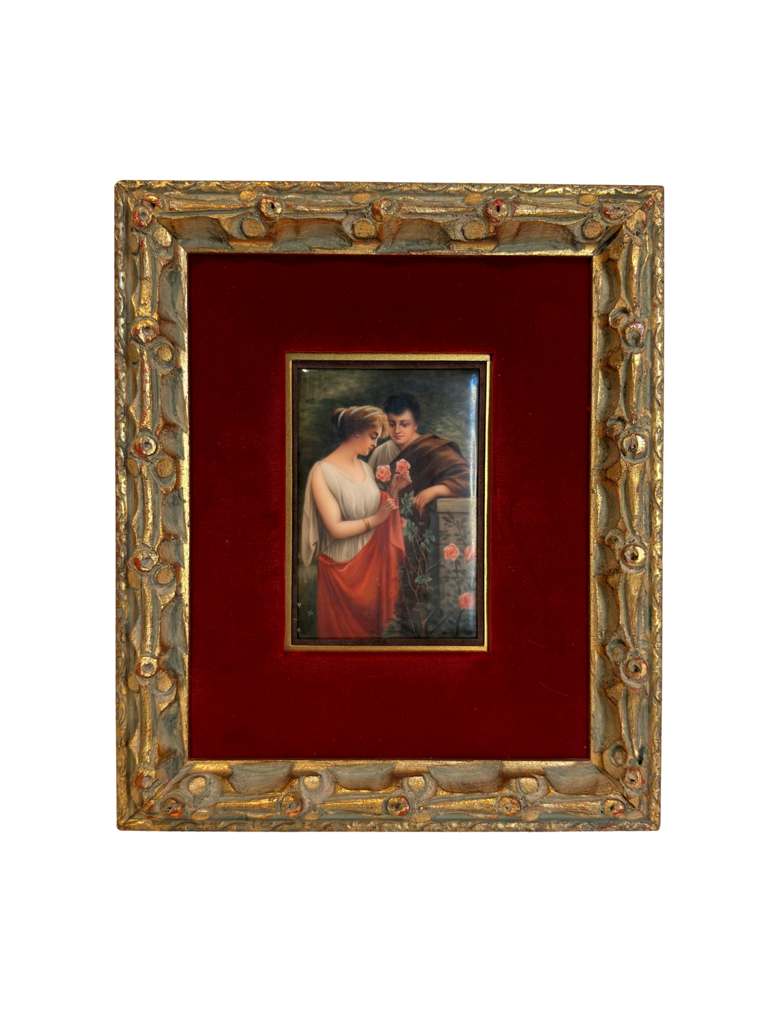 Small painting of couple with roses  within a decorative gold frame on a red background