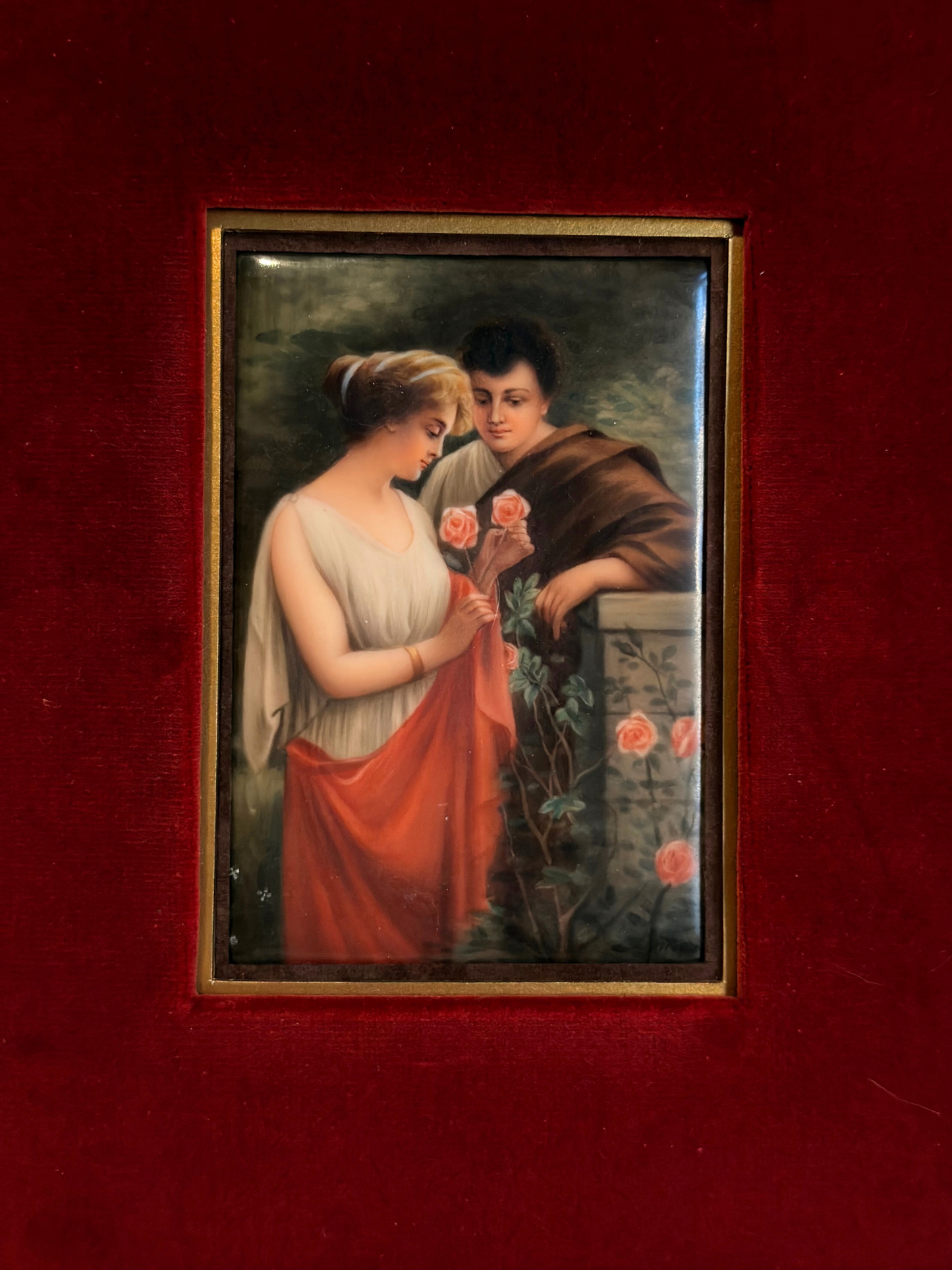 Vintage painting of a couple holding roses on a red background