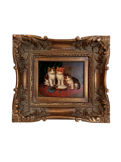 Decorative painting of three cats in a ornate gold frame on a white background