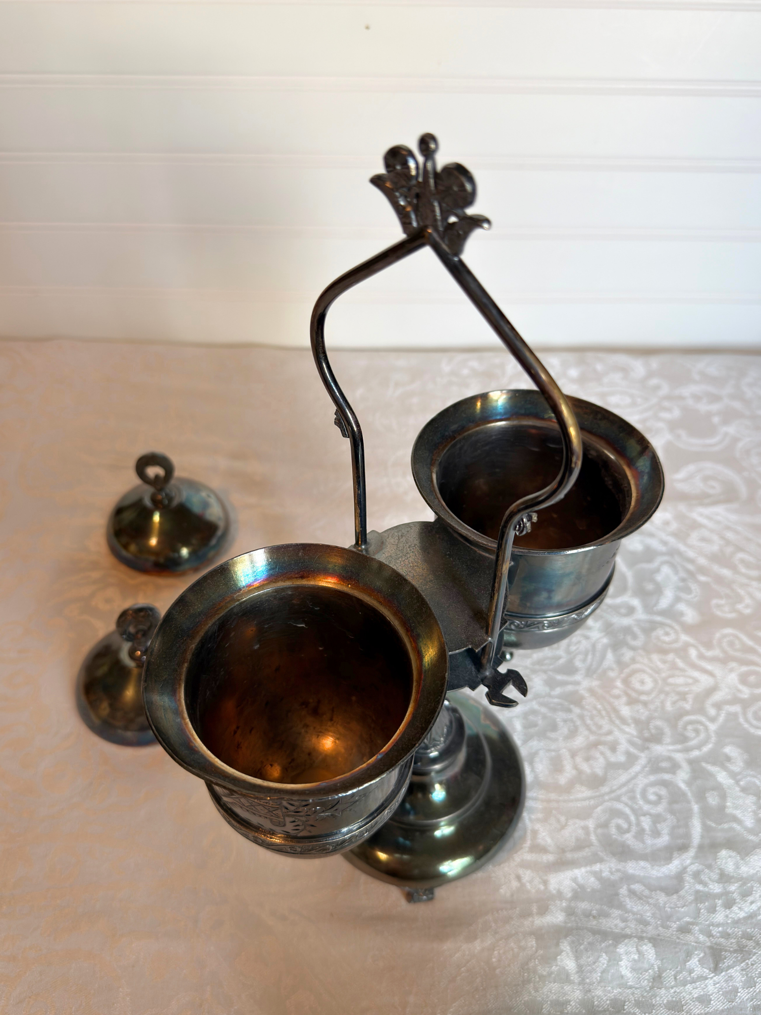 Double Silver plated Pickle castor with a figural lady with the tops off on a white background