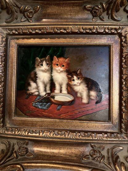 Oil painting of three kittens around a bowl in an ornate gold frame.