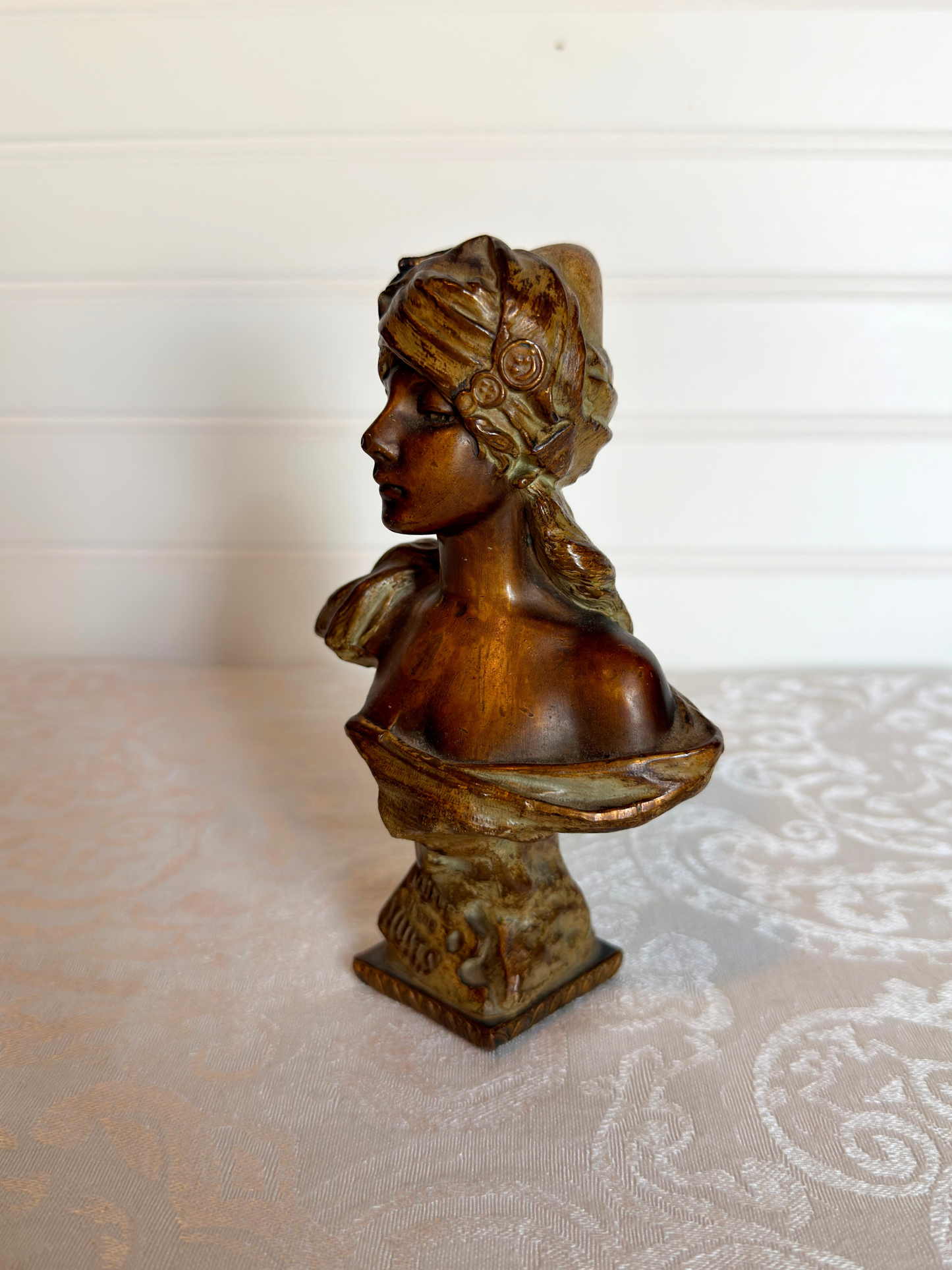 Small statue of girl on a white background