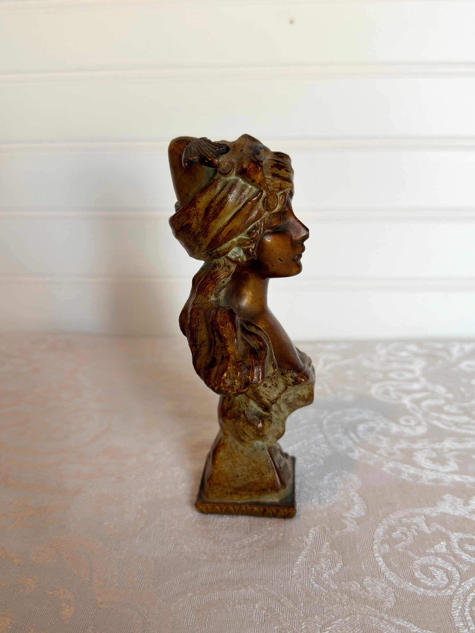 Small statue of girl on a white background