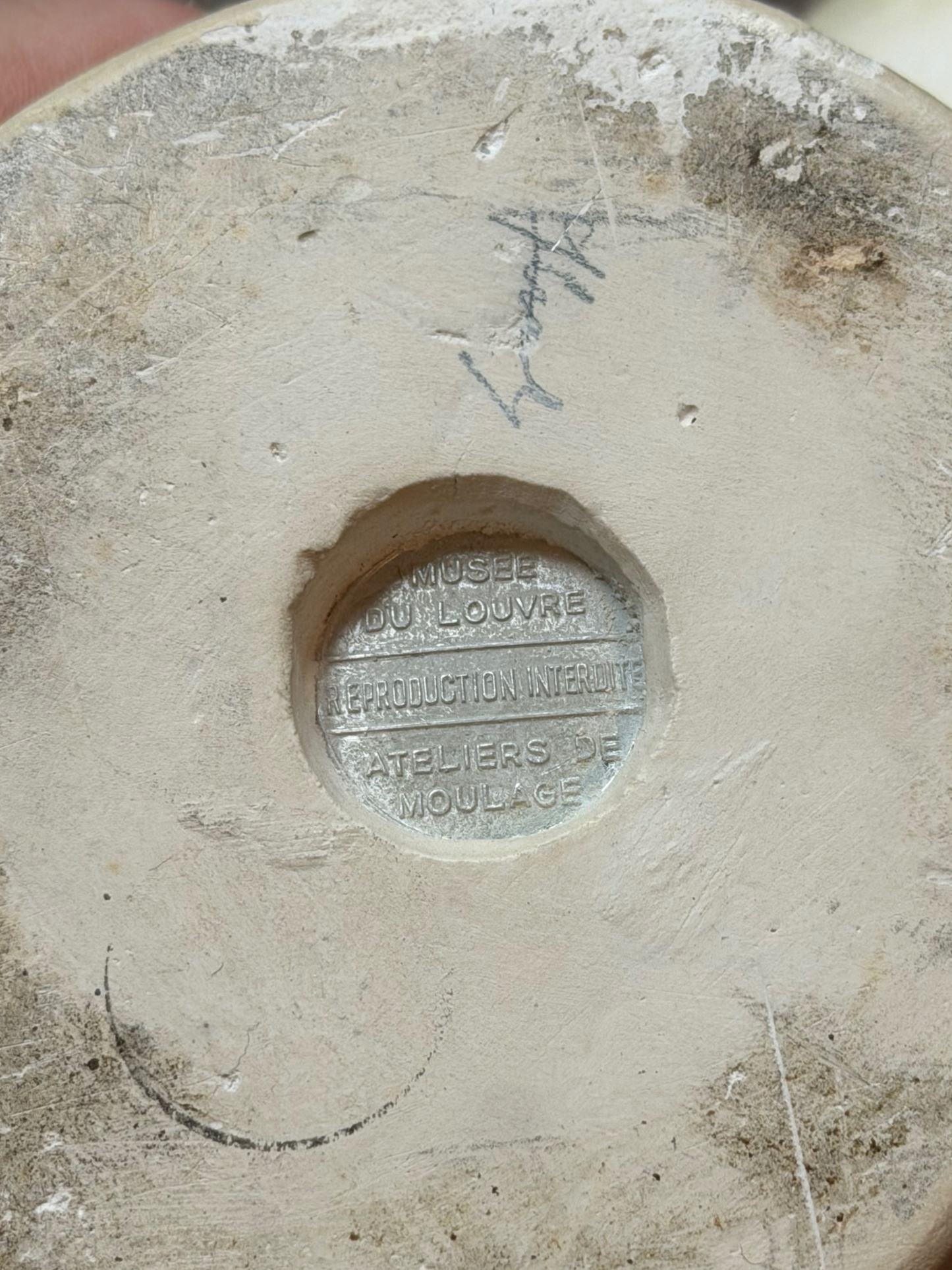 Base of a sculpture with Louvre Museum stamp