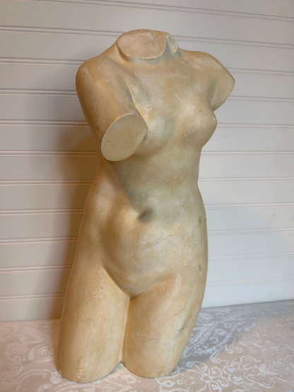 sculpture of a female torso on a neutral background