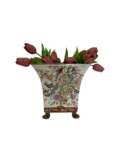 Decorative vase with floral design and tulips on a white background