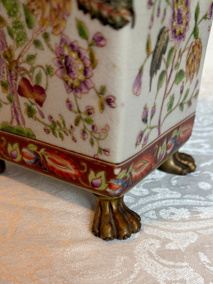 close up of vase with lion feet 