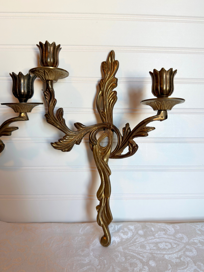 ornate brass wall sconce on a white background