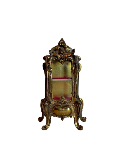 ornate vitrine jewelry box with red shelf on a white background