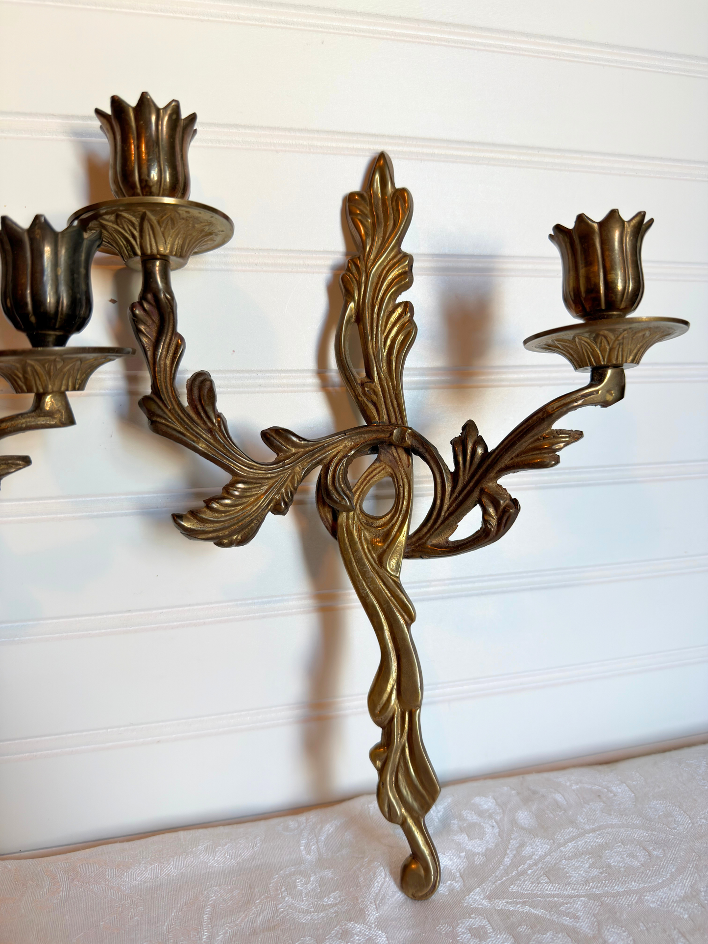  ornate brass wall sconces on a white background