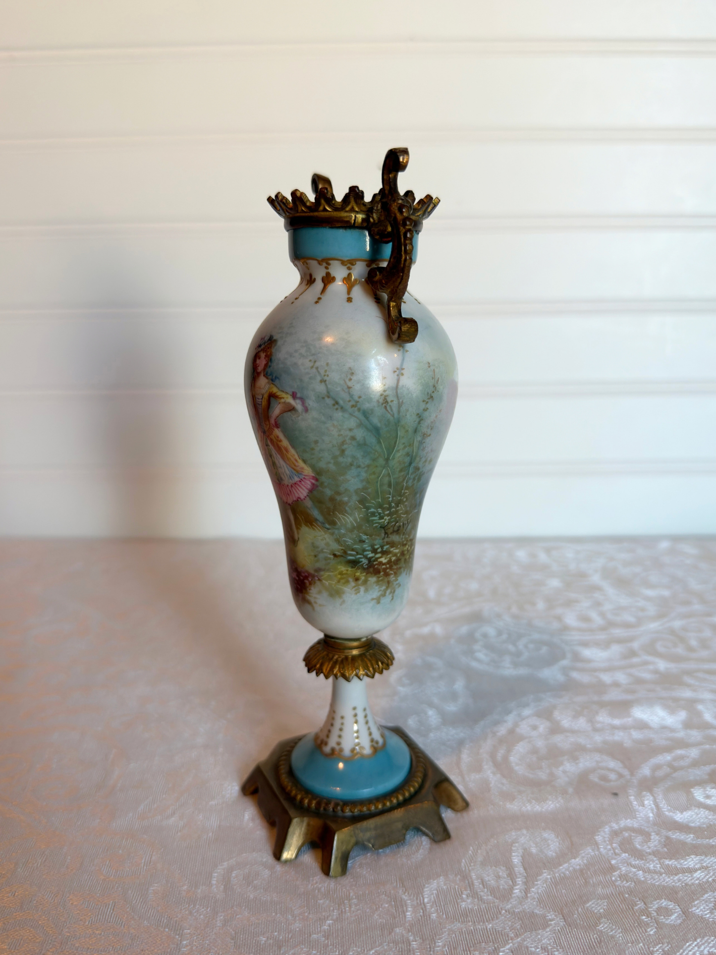 Decorative porcelain and bronze  vase with a painted lady on a white background
