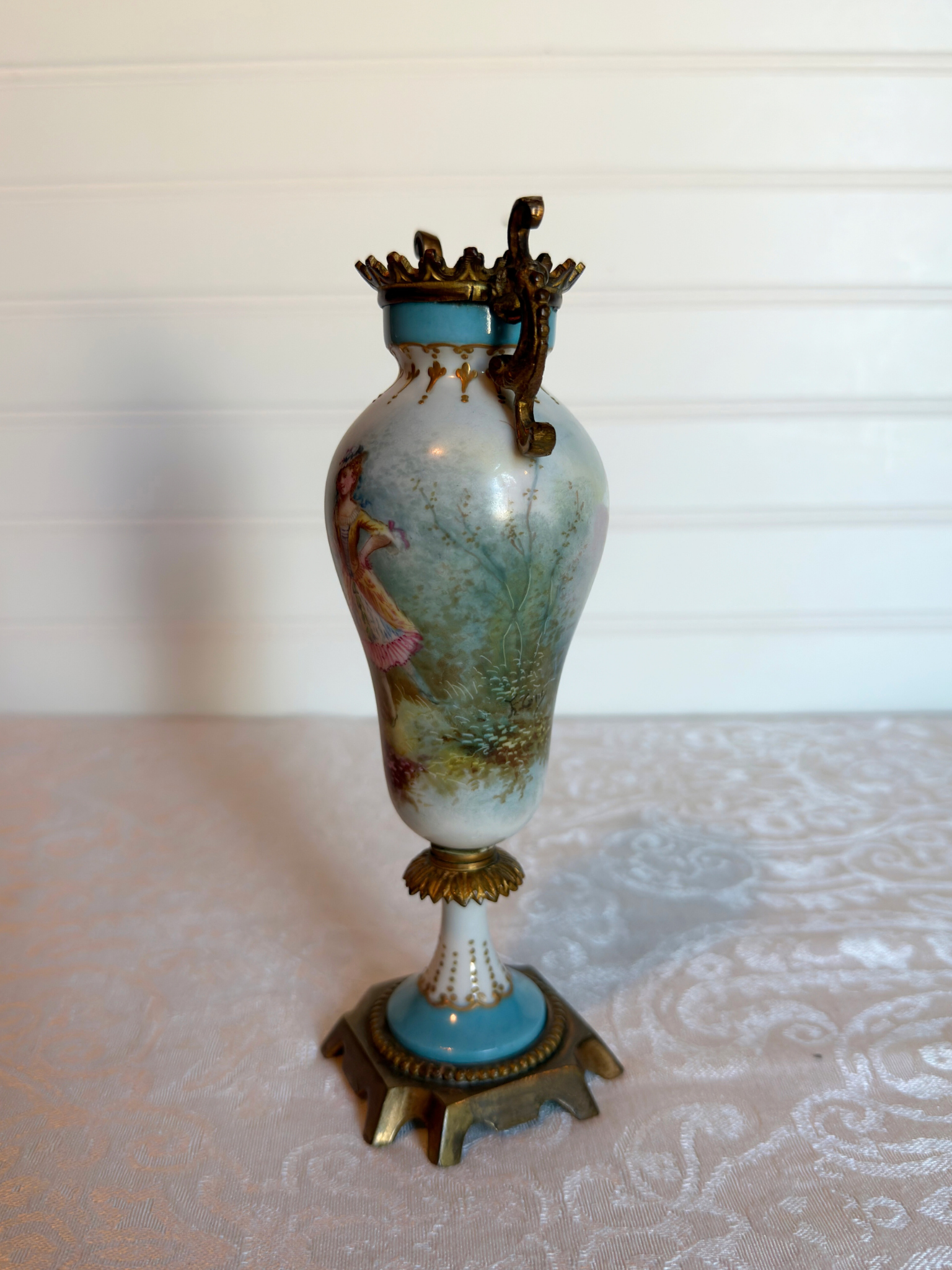 Decorative porcelain and bronze  vase with a painted lady on a white background