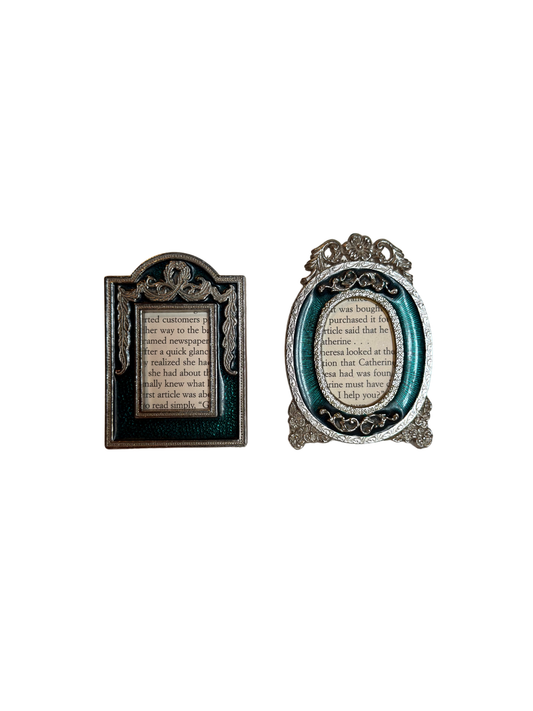 Two decorative teal and silver mini frames with text inside on a white background