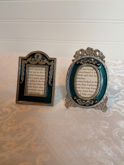 Two decorative teal and silver mini frames with text inside on a white background