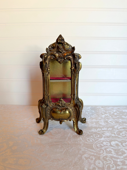 ornate vitrine jewelry box with red shelf on a white background