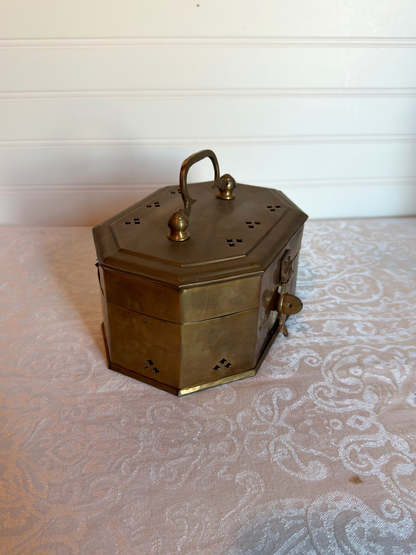 brass cricket box with handle on a white background