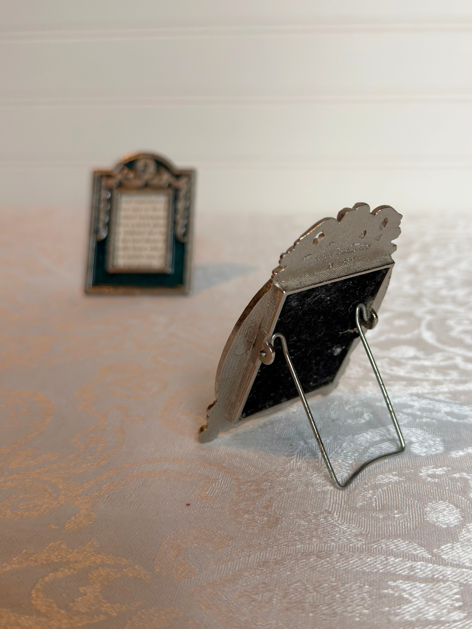 back of Small decorative picture frame on a textured surface