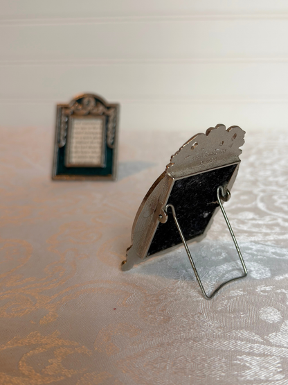 back of Small decorative picture frame on a textured surface