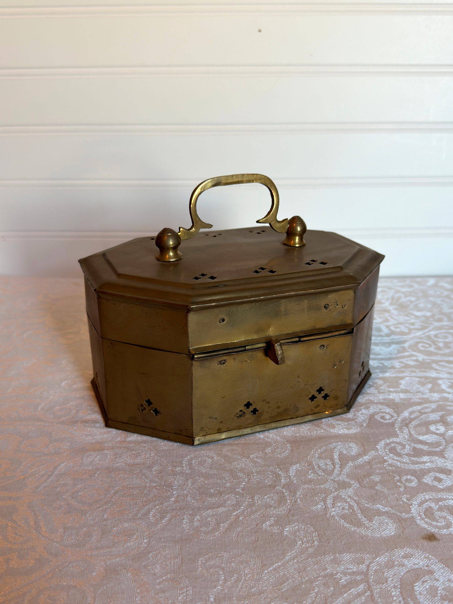 brass cricket box with handle on a white background