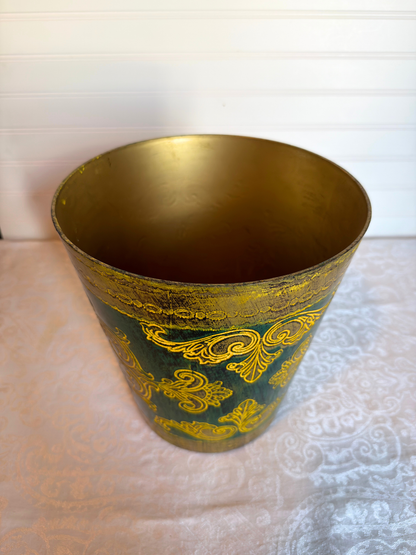 top of Decorative wastebasket with gold patterns on a green background