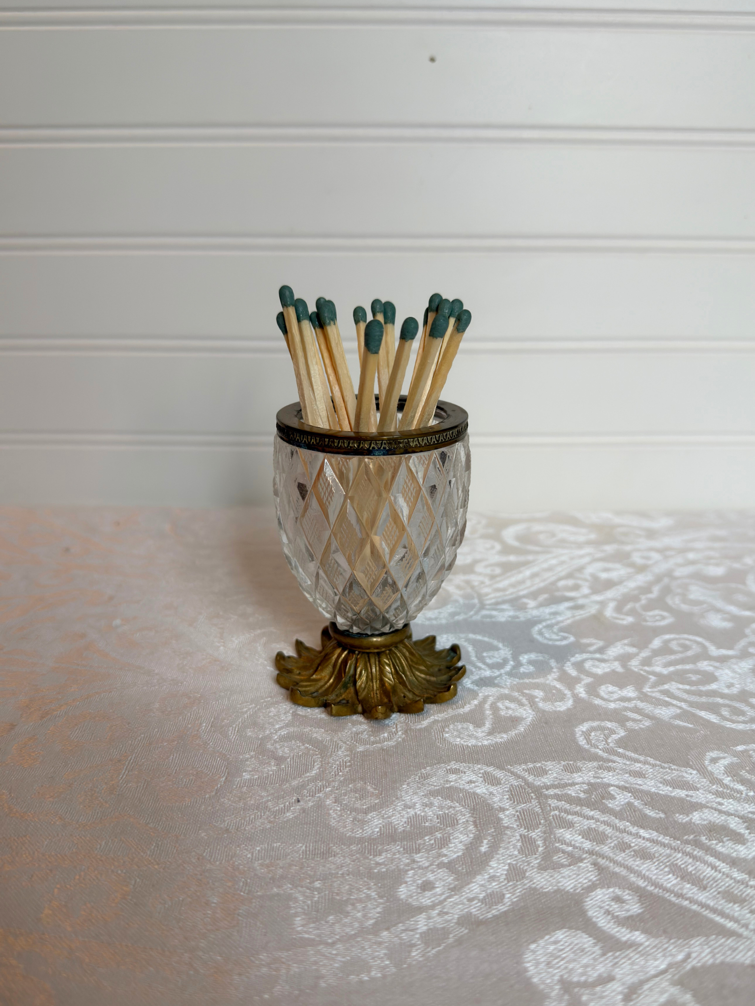 Decorative crystal  match holder with matches on a white background