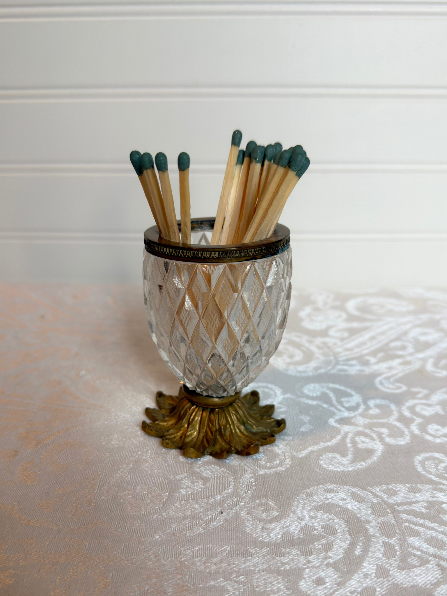 Decorative crystal  match holder with matches on a white background